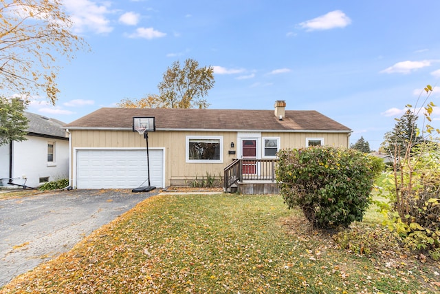 single story home with a front yard and a garage