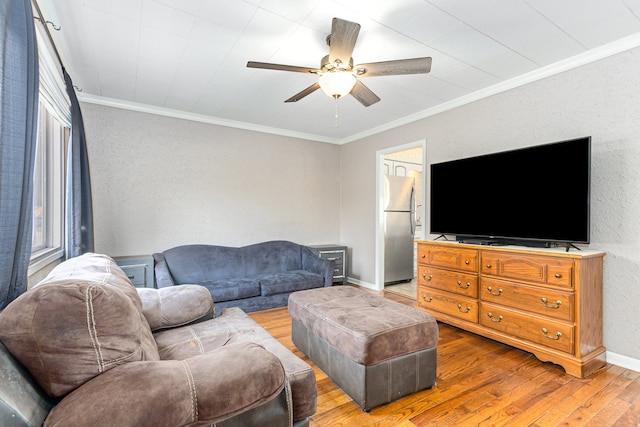 living room with ceiling fan, ornamental molding, and hardwood / wood-style floors