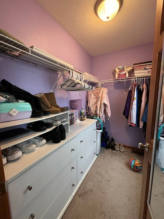 walk in closet featuring carpet