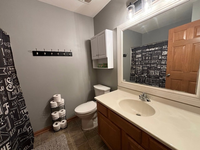 bathroom featuring toilet, vanity, and tile patterned floors