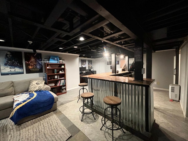 bar featuring butcher block counters and concrete floors