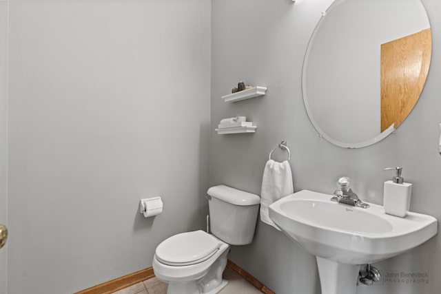 bathroom featuring tile patterned flooring, toilet, and sink