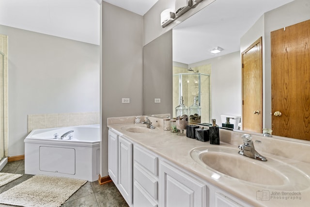 bathroom with tile patterned floors, vanity, and separate shower and tub