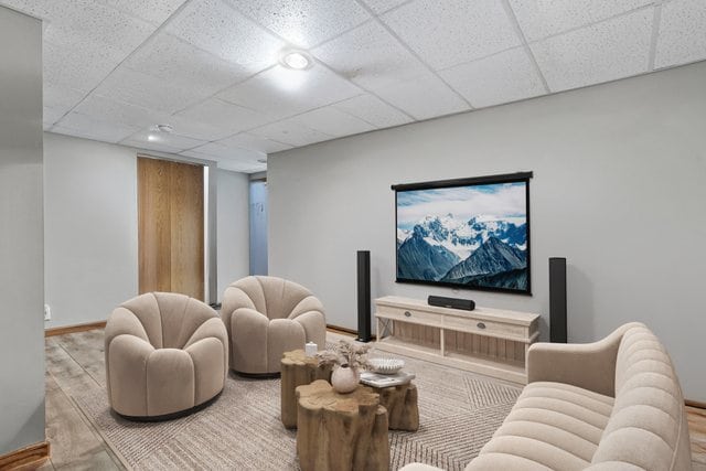 living room with a paneled ceiling