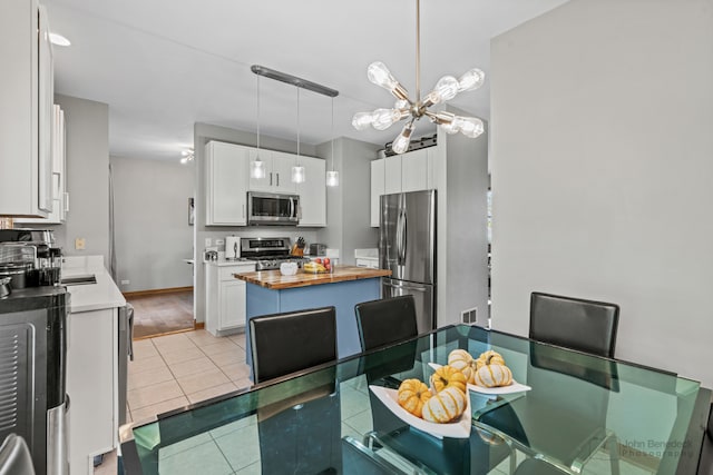 dining area featuring light hardwood / wood-style floors and a chandelier