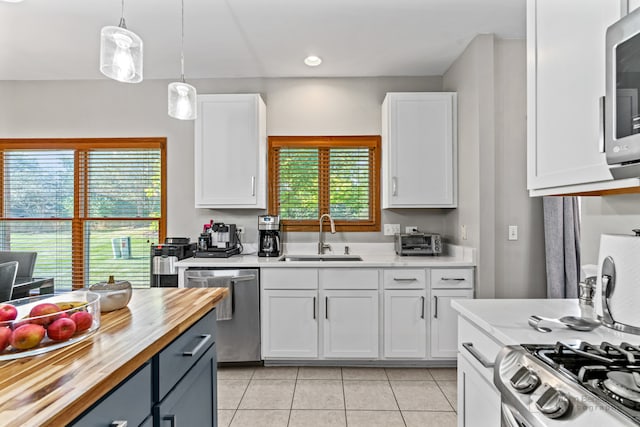 kitchen featuring white cabinets, appliances with stainless steel finishes, and sink