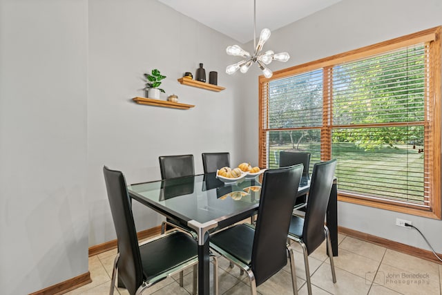 tiled dining space with a notable chandelier