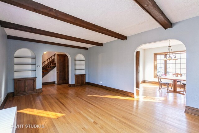 bedroom with hardwood / wood-style floors, radiator, and lofted ceiling