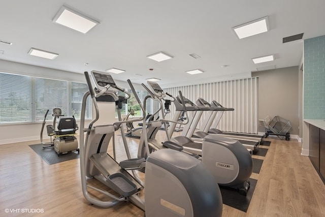 gym with light hardwood / wood-style floors