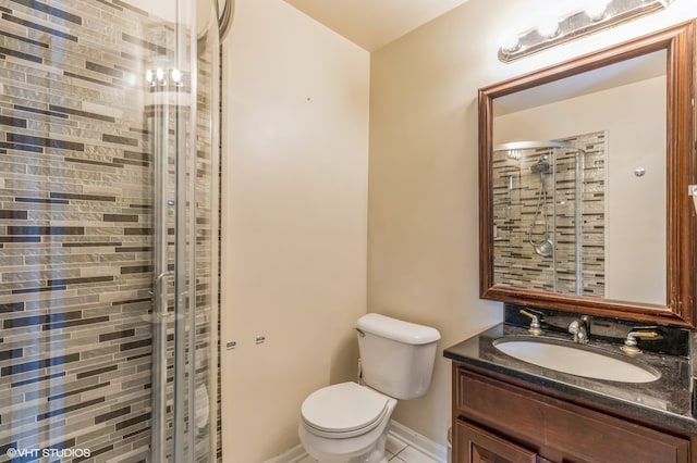 bathroom with vanity, toilet, tile patterned floors, and a shower with shower door