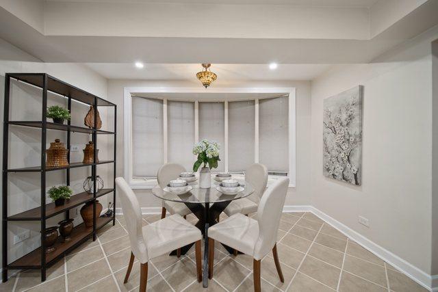 dining space featuring light tile patterned floors, recessed lighting, and baseboards