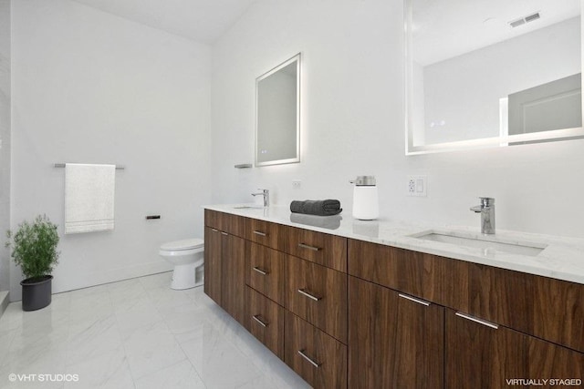 bathroom featuring vanity and toilet