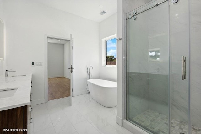 bathroom featuring vanity and shower with separate bathtub