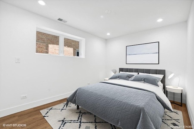 bedroom with hardwood / wood-style flooring