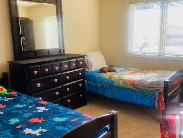 bedroom featuring light carpet