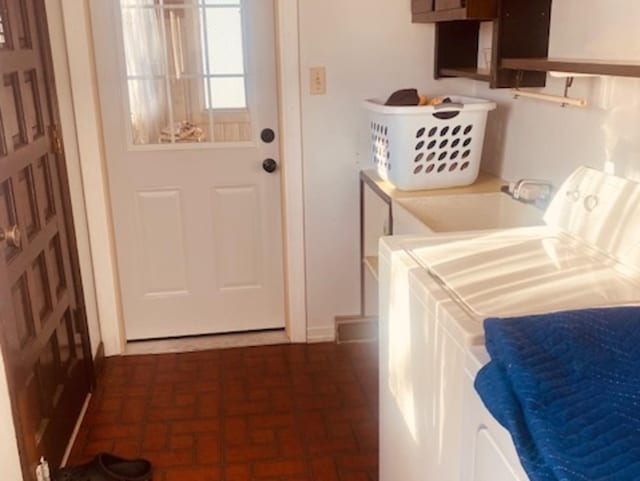 washroom with washer and clothes dryer and sink