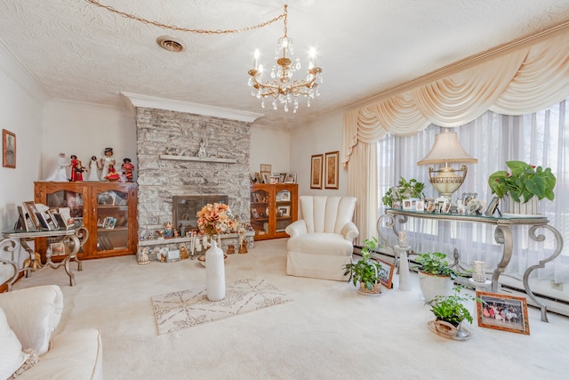 carpeted living room featuring ornamental molding, a fireplace, a textured ceiling, and an inviting chandelier