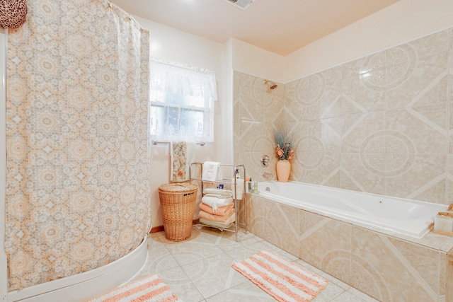 bathroom with tiled bath and tile patterned flooring