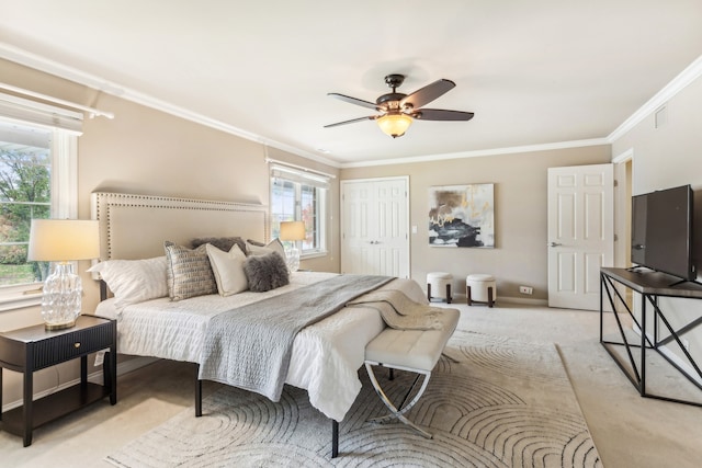 bedroom featuring ornamental molding, light carpet, a closet, and ceiling fan