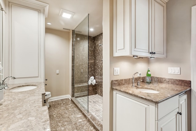 bathroom featuring vanity, toilet, and walk in shower