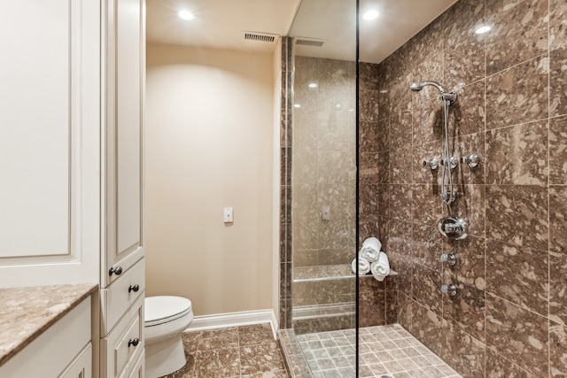 bathroom featuring toilet, walk in shower, and vanity