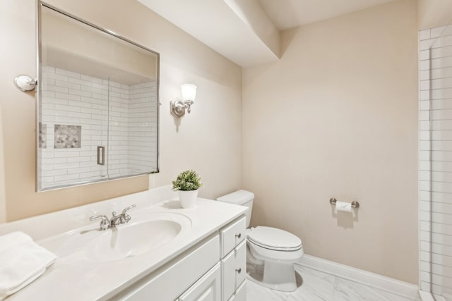 bathroom featuring vanity, toilet, and a shower with shower door