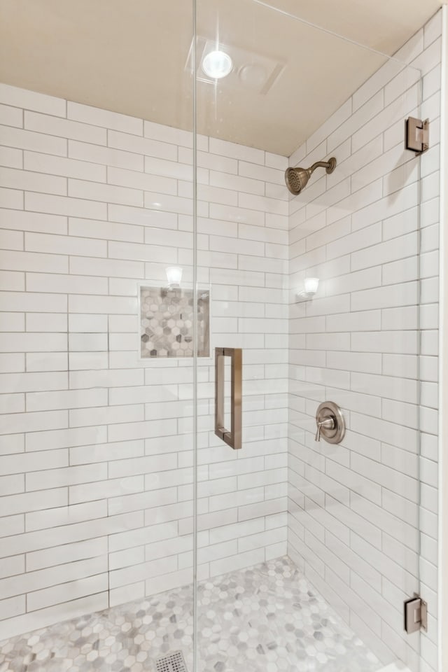 bathroom with a shower with shower door