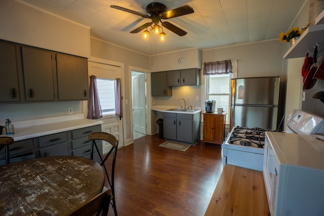 kitchen featuring plenty of natural light, stainless steel fridge, dark hardwood / wood-style flooring, and sink