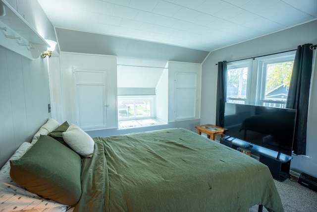 carpeted bedroom featuring vaulted ceiling