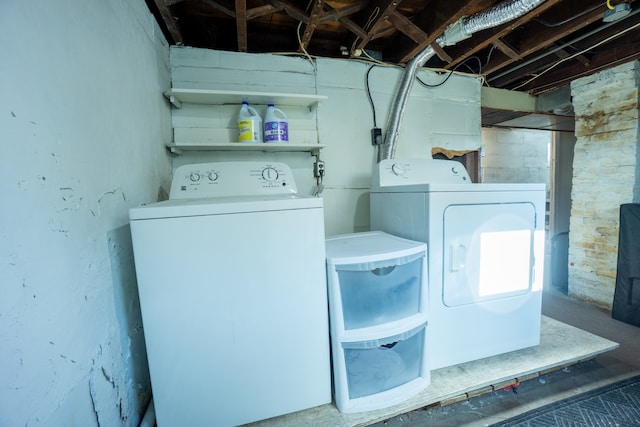 clothes washing area with washing machine and dryer