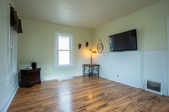 living room with crown molding and wood-type flooring