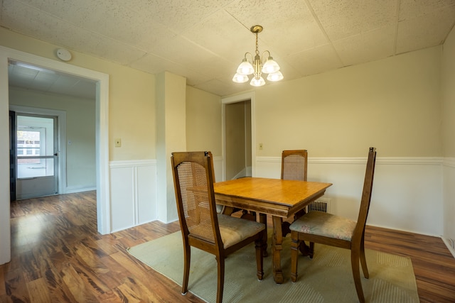 dining area featuring a chandelier and dark wood-type flooring