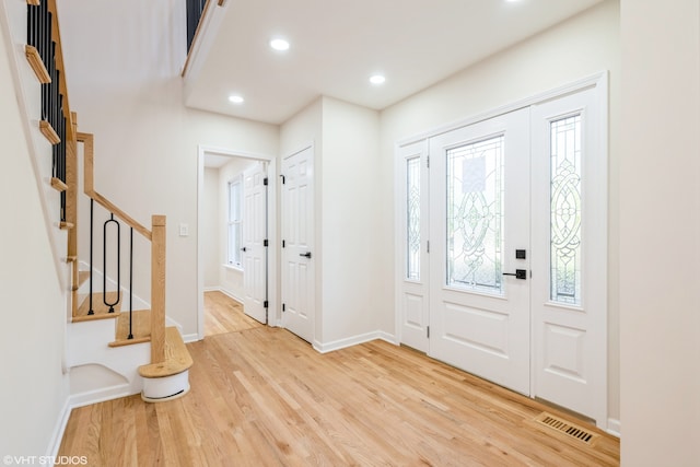 foyer entrance with light hardwood / wood-style floors and a wealth of natural light