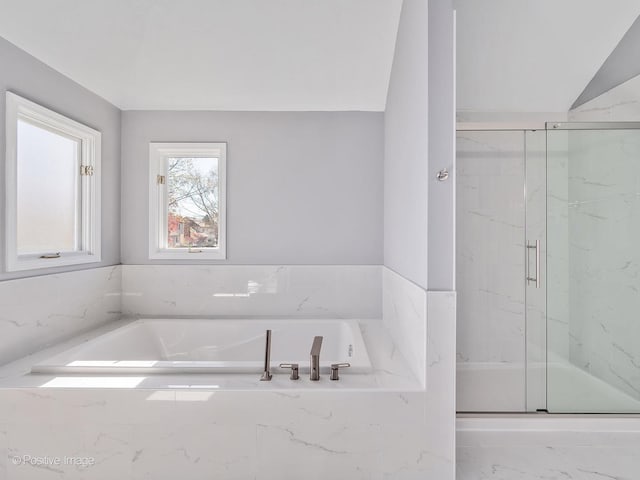 bathroom with lofted ceiling and plus walk in shower