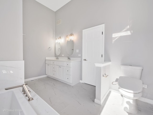 bathroom featuring toilet and vanity