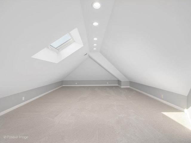 additional living space with carpet flooring and vaulted ceiling