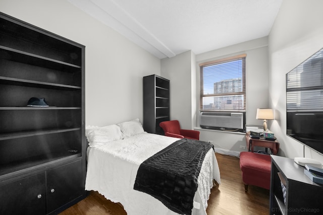 bedroom featuring cooling unit and dark wood-type flooring