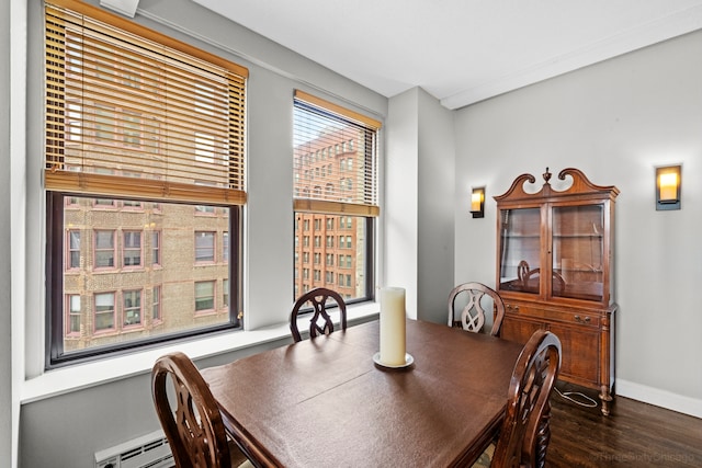 dining area with dark wood-type flooring and a baseboard radiator