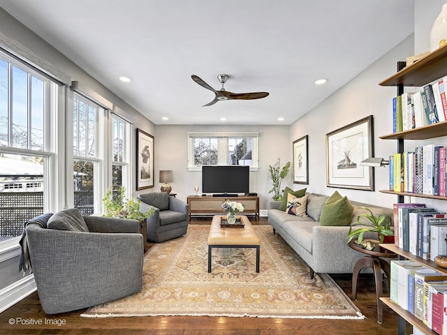 living room featuring ceiling fan, plenty of natural light, and hardwood / wood-style floors