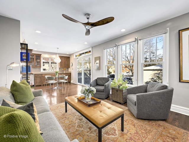 living room featuring ceiling fan and light wood-type flooring