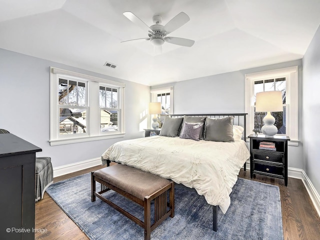 bedroom with dark hardwood / wood-style flooring and ceiling fan