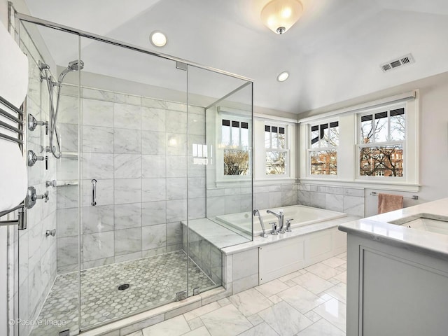 bathroom featuring separate shower and tub, vanity, and lofted ceiling