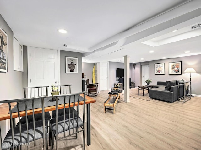 interior space featuring light hardwood / wood-style flooring and ornate columns