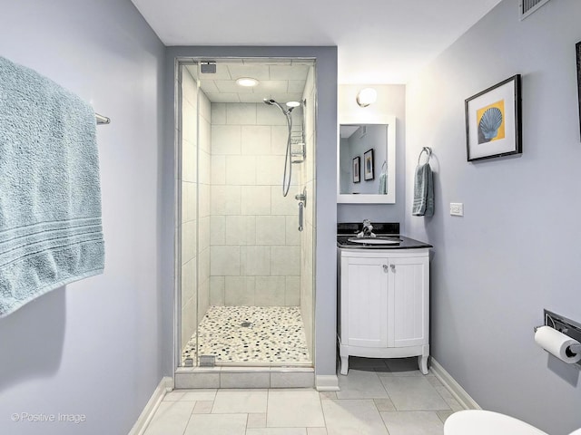 bathroom featuring toilet, vanity, tile patterned flooring, and an enclosed shower