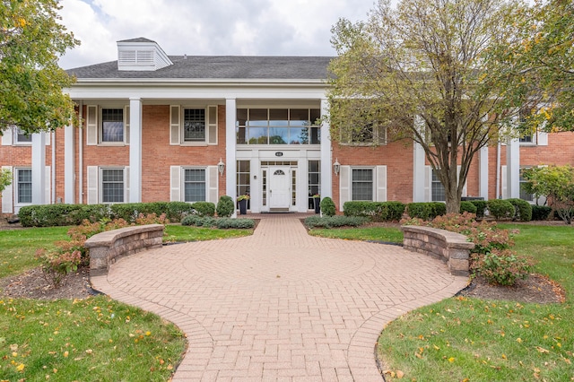 greek revival house with a front lawn