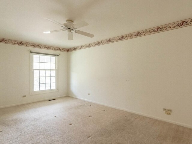 carpeted empty room with ceiling fan