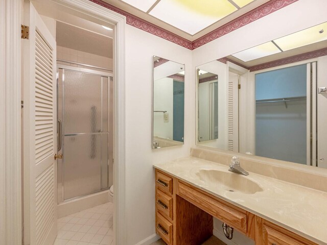 bathroom featuring vanity and a shower with shower door