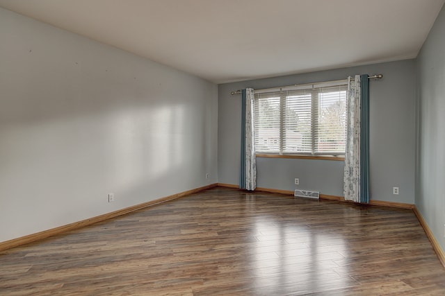 unfurnished room featuring dark hardwood / wood-style flooring