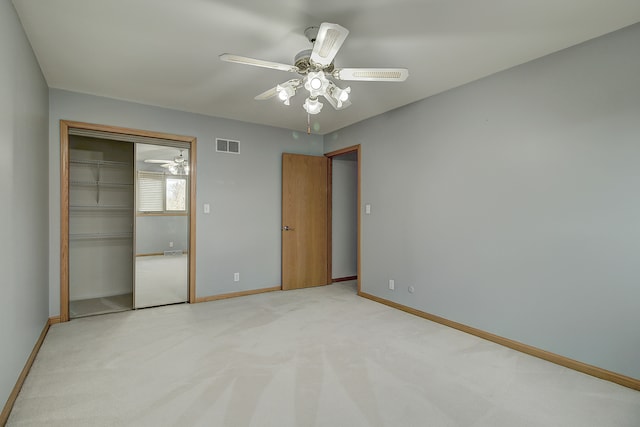 unfurnished bedroom with light carpet, a closet, and ceiling fan