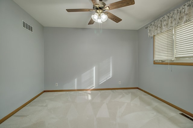 empty room with ceiling fan and carpet